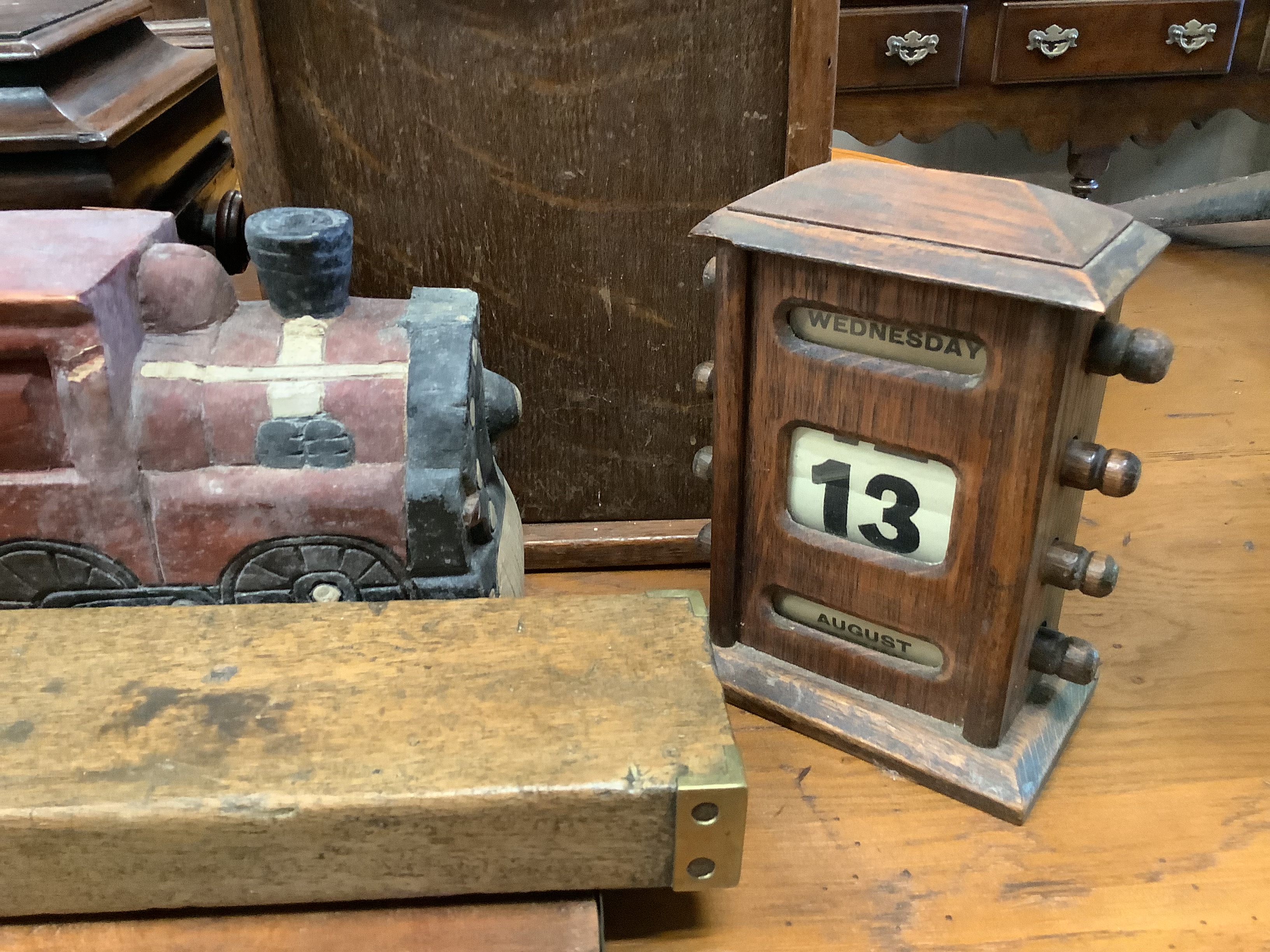 A Shove Ha'penny board, a Preston & Sons brass-mounted spirit level, a Riley's billiards scoreboard and a tea caddy